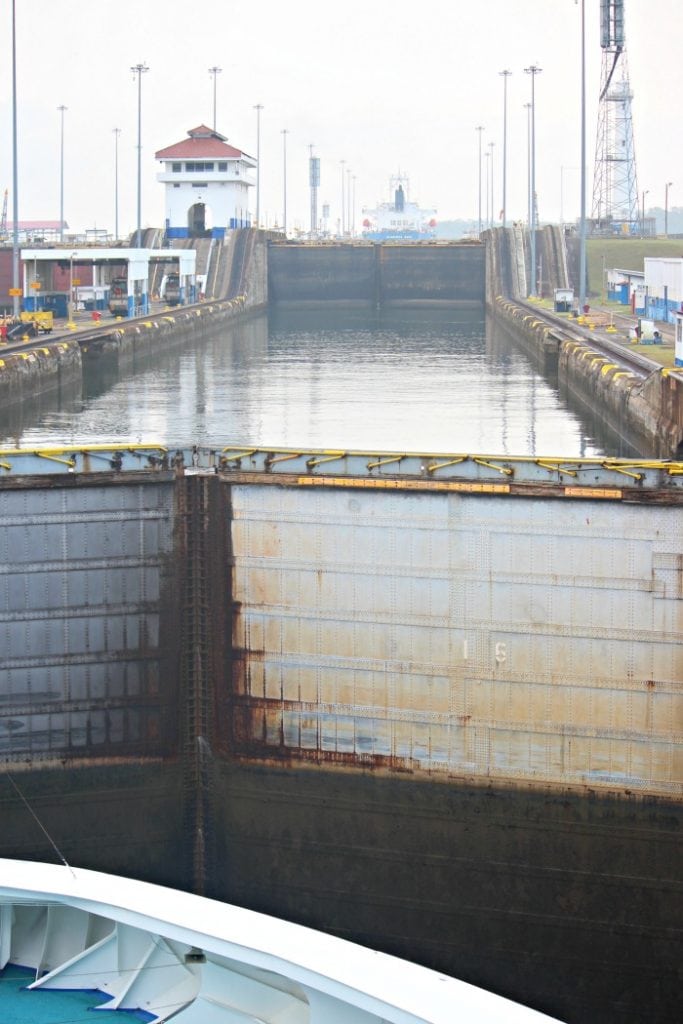 view from the rear of the ship going through the panama canal lock system
