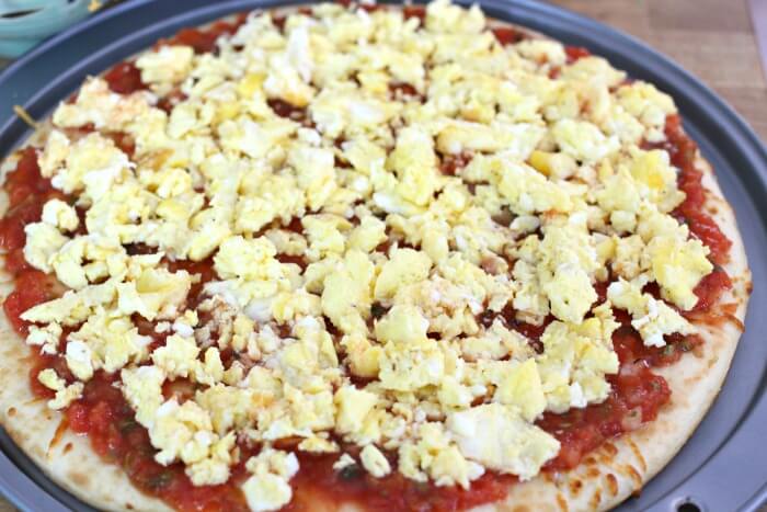 fluffy scrambled eggs and salsa on pizza