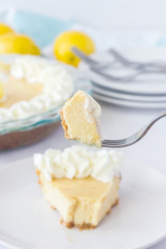 LEMON PIE RECIPE ON A PLATE WITH A BITE ON A FORK