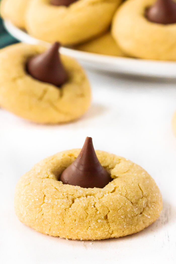 Peanut Butter Blossoms (Hershey Kiss Cookies) are pillowy soft peanut butter cookies rolled in sugar & topped with a Hershey's Kiss. HERSHEY'S PEANUT BUTTER BLOSSOMS