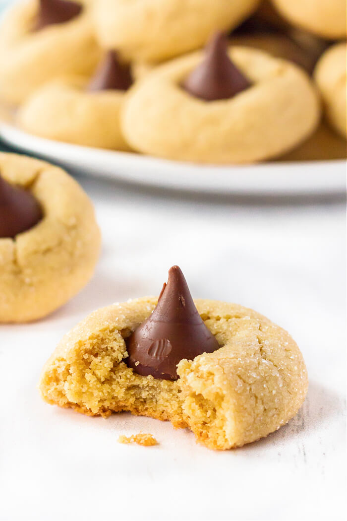 Peanut Butter Blossoms (Hershey Kiss Cookies) are pillowy soft peanut butter cookies rolled in sugar & topped with a Hershey's Kiss. PEANUT BUTTER BLOSSOM COOKIE RECIPE