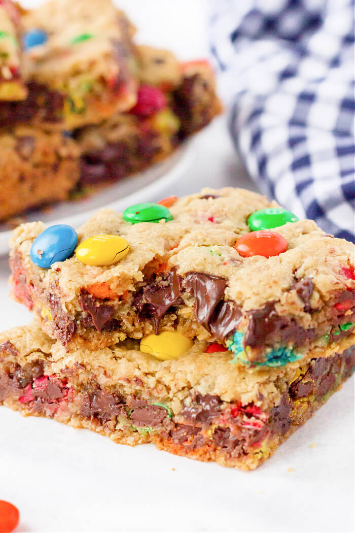 Monster cookie bars are ooey gooey peanut butter, oatmeal, and M&M filled dessert bars that are bound to put a smile on your face! EASY MONSTER COOKIE BARS