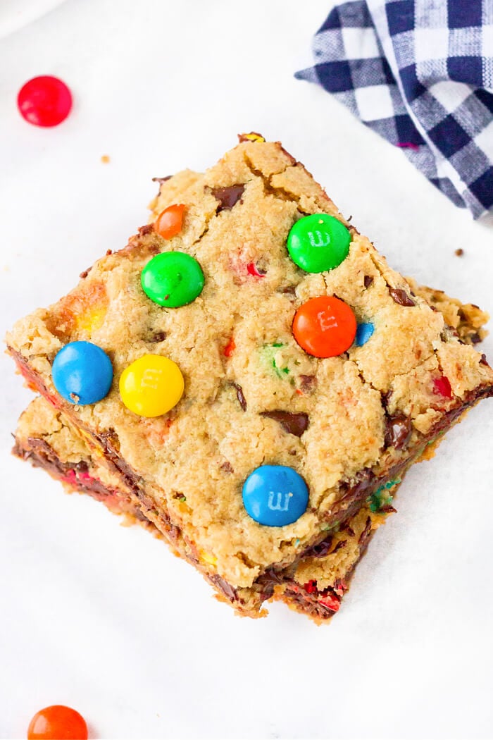 Monster cookie bars are ooey gooey peanut butter, oatmeal, and M&M filled dessert bars that are bound to put a smile on your face! HOMEMADE MONSTER COOKIE BARS