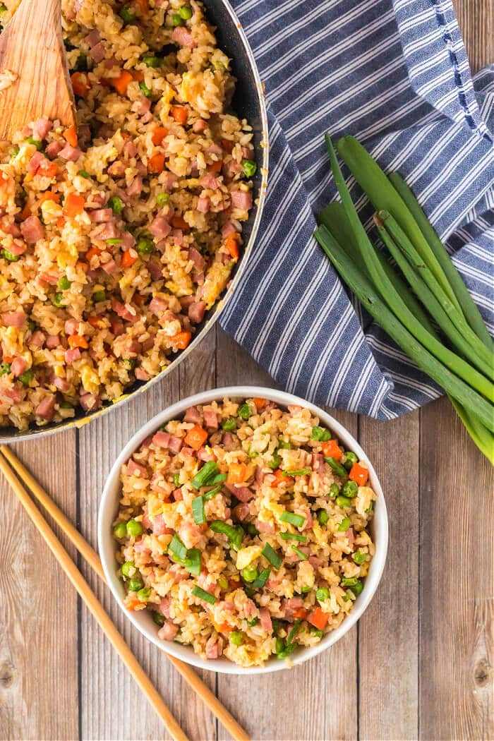 Ham fried rice is a flavorful and simple dish made with ham, peas, carrots, seasoned rice, and eggs topped for an easy weeknight meal! HAM IN FRIED RICE