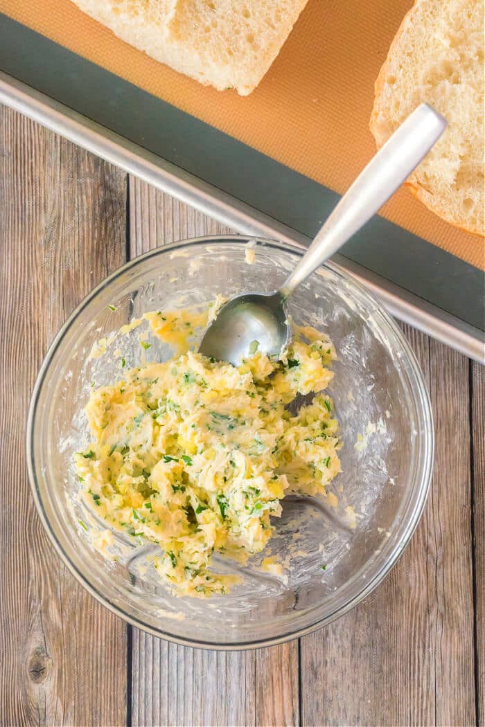 Garlic bread made with fresh bread and loaded with butter, garlic cloves and fresh chopped parsley is the perfect addition to any meal! HOW DO YOU MAKE GARLIC BREAD