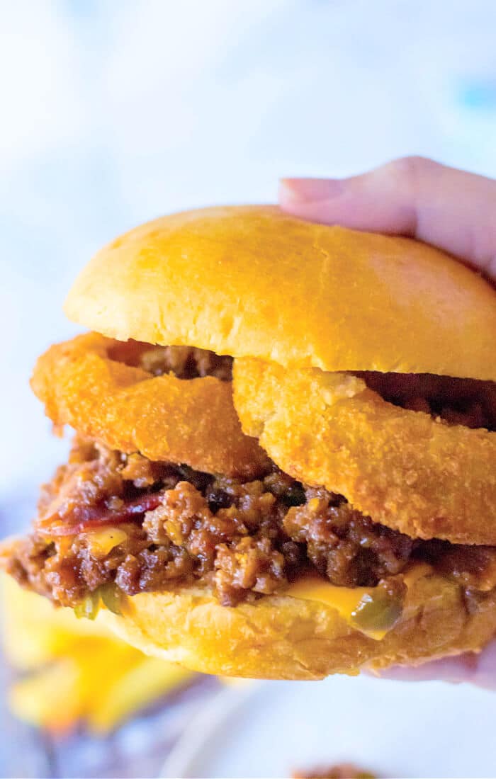 Cowboy sloppy joes are a fun spin on the original made with BBQ sauce, bacon, diced green peppers & onion served with crispy onion rings! RECIPE FOR COWBOY SLOPPY JOES