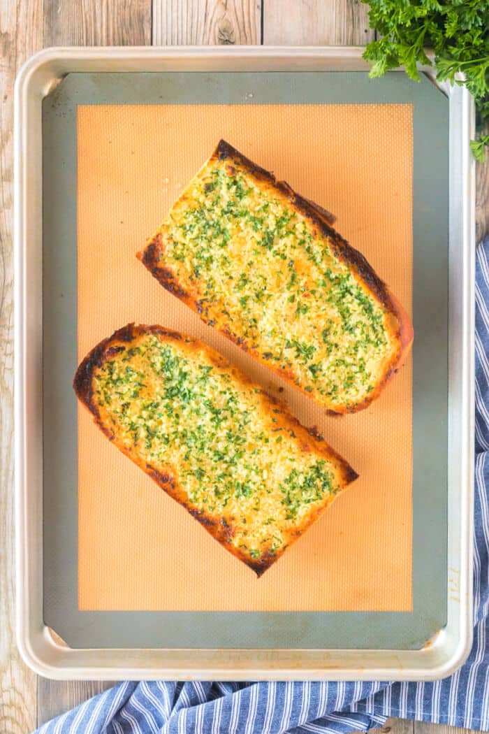 Garlic bread made with fresh bread and loaded with butter, garlic cloves and fresh chopped parsley is the perfect addition to any meal! RECIPE FOR GARLIC BREAD