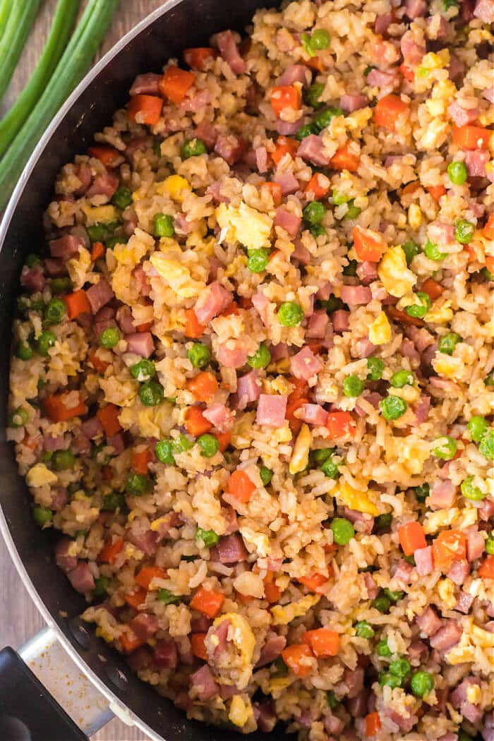 Ham fried rice is a flavorful and simple dish made with ham, peas, carrots, seasoned rice, and eggs topped for an easy weeknight meal! RECIPE FOR HAM FRIED RICE