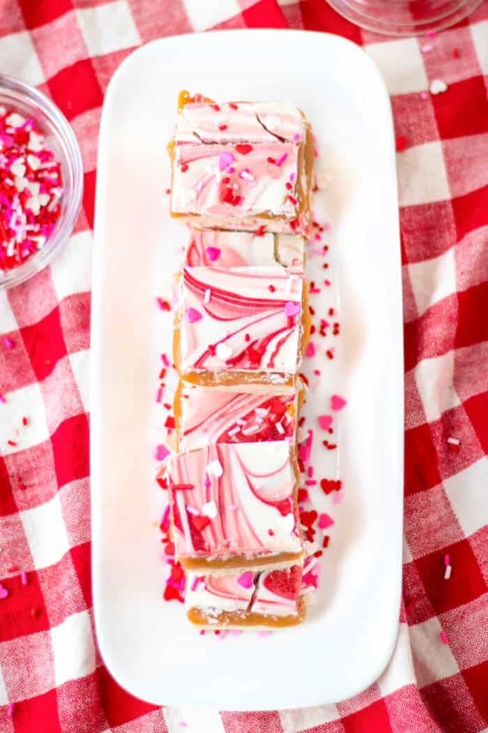 Valentine’s millionaire bars are a layered dessert made with shortbread, caramel, creamy chocolate and topped with Valentine sprinkles! VALENTINE'S DESSERT BARS