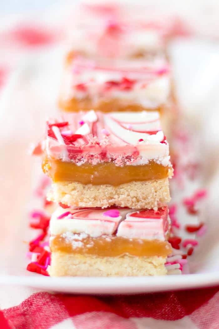 Valentine’s millionaire bars are a layered dessert made with shortbread, caramel, creamy chocolate and topped with Valentine sprinkles! VALENTINE'S MILLIONAIRE BARS