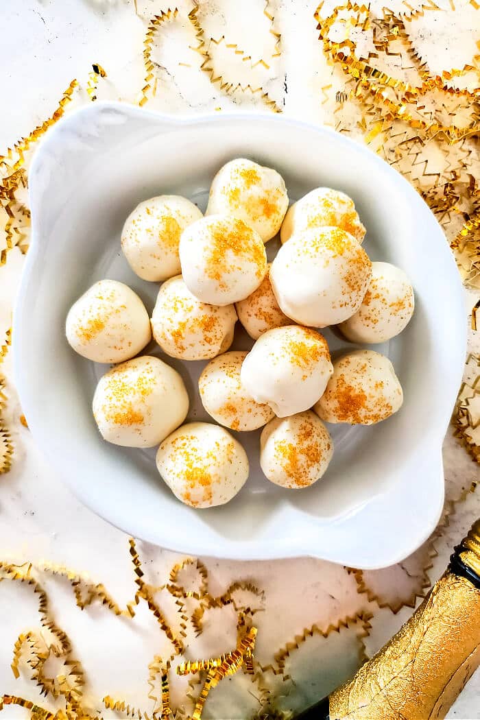 Champagne truffles are a decadent dessert made with white chocolate, cream and champagne topped with gold sprinkles for extra fancy flair! WHITE CHOCOLATE CHAMPAGNE TRUFFLES RECIPE
