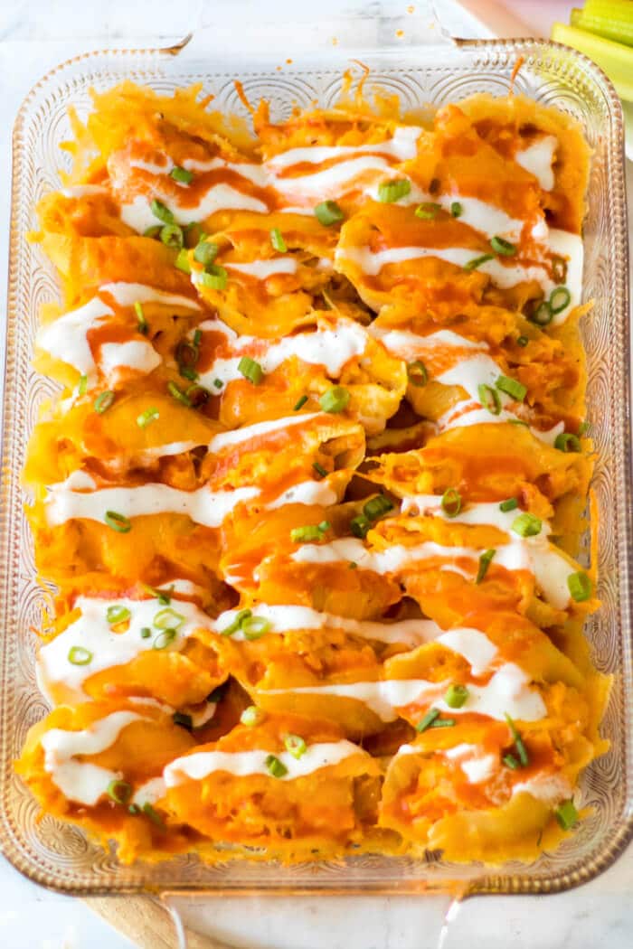 Buffalo chicken stuffed shells are jumbo pasta shells stuffed with cheesy chicken and wing sauce, it's the perfect fusion meal! BAKED BUFFALO CHICKEN STUFFED SHELLS