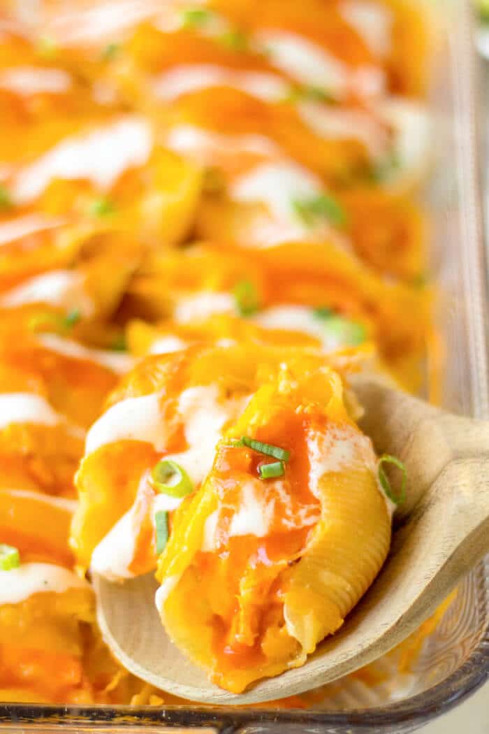 Buffalo chicken stuffed shells are jumbo pasta shells stuffed with cheesy chicken and wing sauce, it's the perfect fusion meal! BUFFALO CHICKEN STUFFED SHELLS