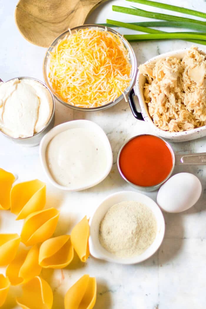 Buffalo chicken stuffed shells are jumbo pasta shells stuffed with cheesy chicken and wing sauce, it's the perfect fusion meal! BUFFALO CHICKEN STUFFED SHELLS INGREDIENTS