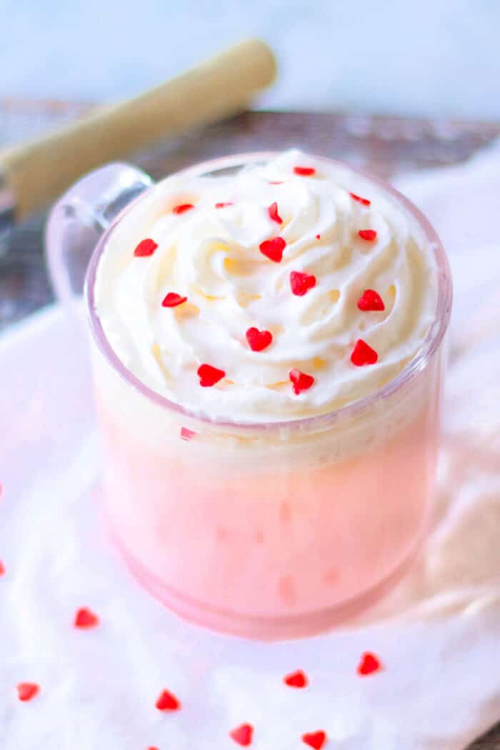 Pink hot chocolate is the perfect pink holiday or party treat; made with sweetened milk and white chocolate then topped with whipped cream! PINK HOT CHOCOLATE RECIPE