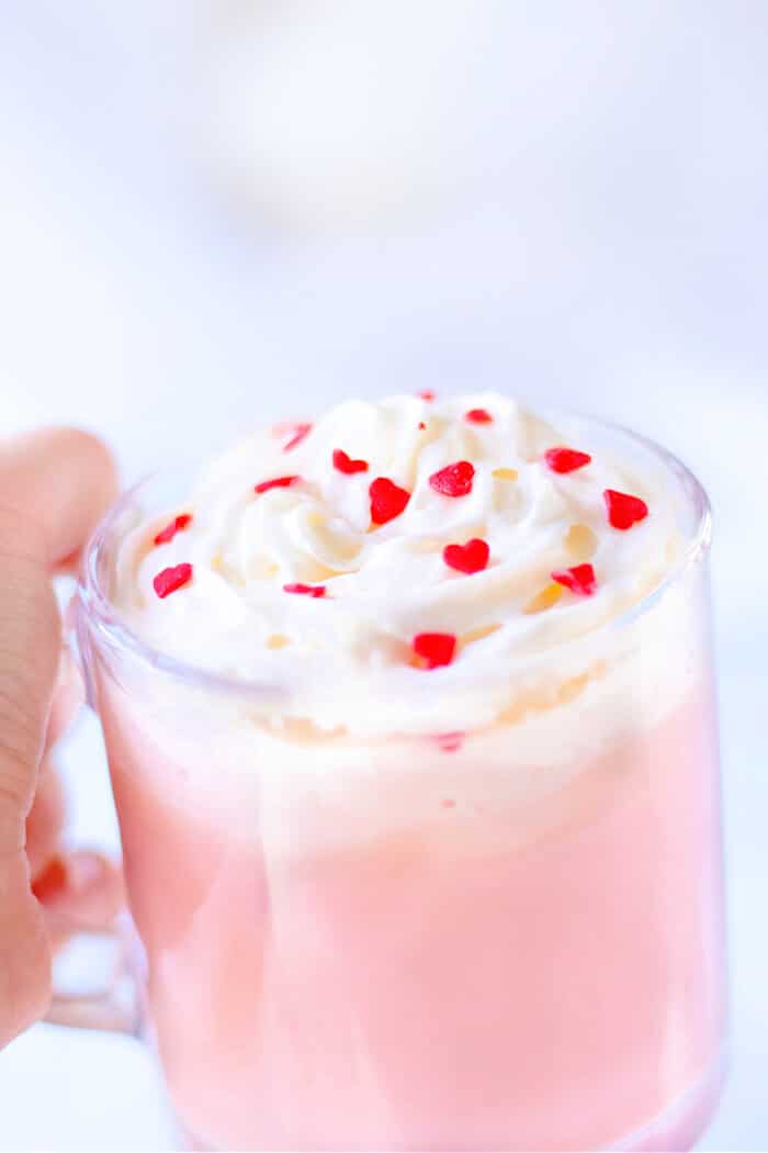 Pink hot chocolate is the perfect pink holiday or party treat; made with sweetened milk and white chocolate then topped with whipped cream! RECIPE FOR PINK HOT CHOCOLATE
