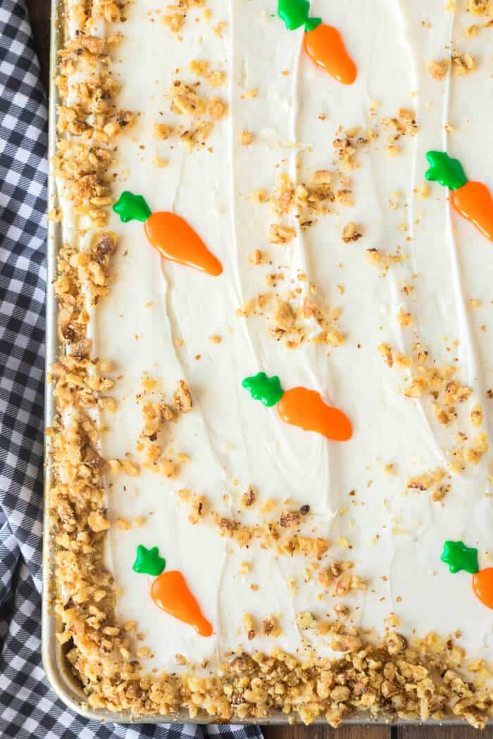 Carrot cake sheet cake is the perfect way to feed a crowd with a super moist homemade cake topped with cream cheese frosting and walnuts. SHEET CARROT CAKE