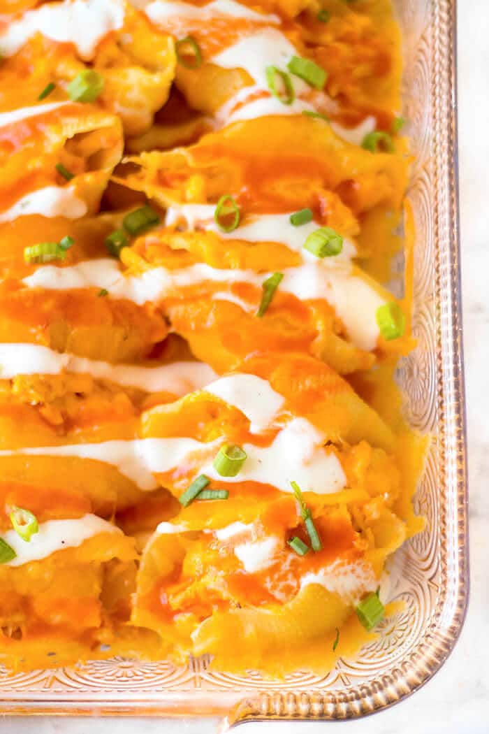 Buffalo chicken stuffed shells are jumbo pasta shells stuffed with cheesy chicken and wing sauce, it's the perfect fusion meal! STUFFED BUFFALO CHICKEN SHELLS