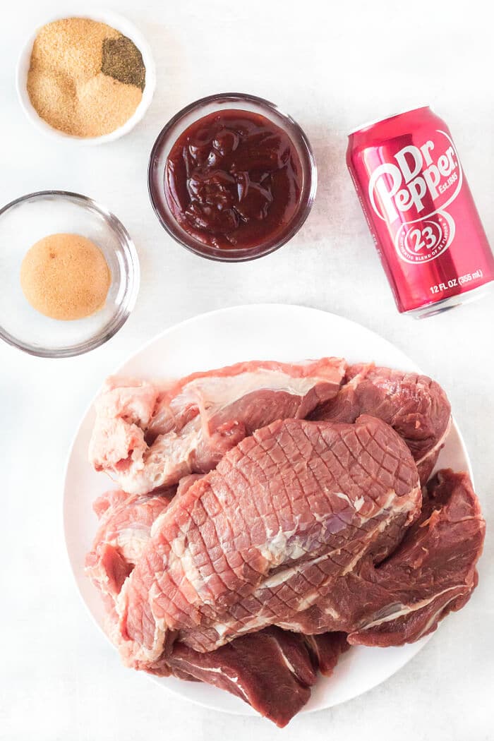 Dr. Pepper pulled pork is loaded with flavor from seasoning and Dr. Pepper and finished with BBQ sauce for an amazing weeknight meal. DR PEPPER PULLED PORK INGREDIENTS