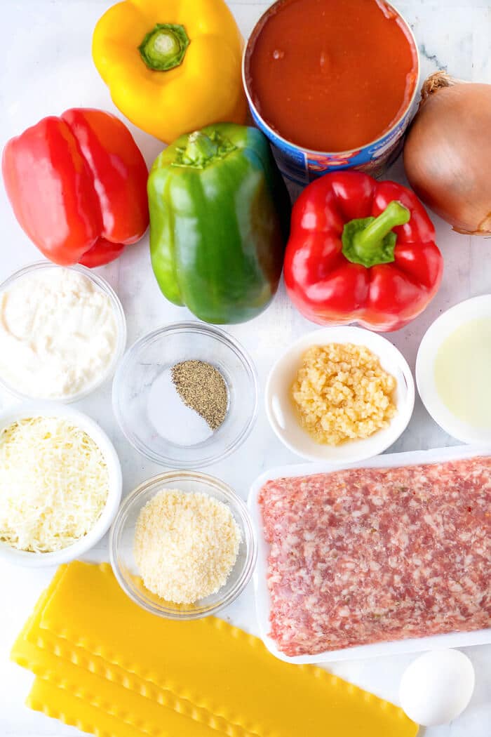 Lasagna stuffed peppers are an fun spin on the classic dish made with bell peppers, sausage, lasagna noodles, sauce and ricotta cheese! LASAGNA STUFFED PEPPERS INGREDIENTS