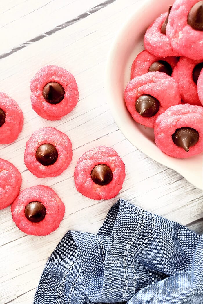 Strawberry kiss cookies are a fun spin on the original made with strawberry cake mix, cream cheese, sugar, and a delicious chocolate kiss! STRAWBERRY BLOSSOM COOKIES