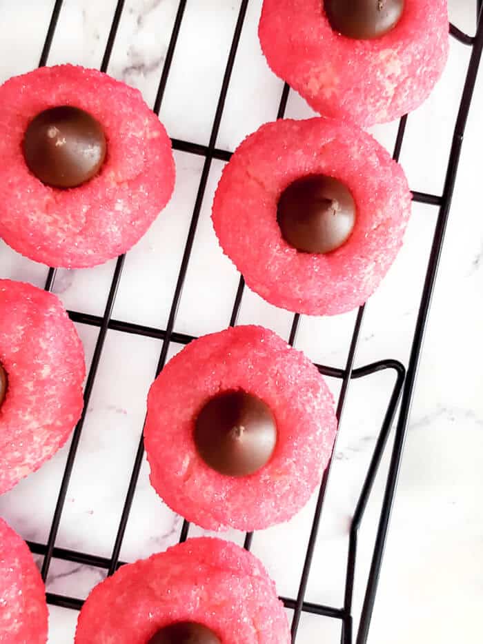 Strawberry kiss cookies are a fun spin on the original made with strawberry cake mix, cream cheese, sugar, and a delicious chocolate kiss! STRAWBERRY HERSHEY KISS COOKIES