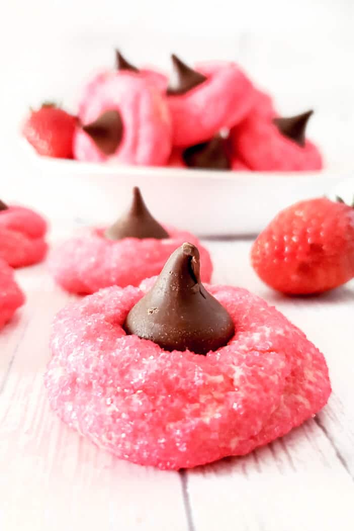 Strawberry kiss cookies are a fun spin on the original made with strawberry cake mix, cream cheese, sugar, and a delicious chocolate kiss! STRAWBERRY KISS COOKIES
