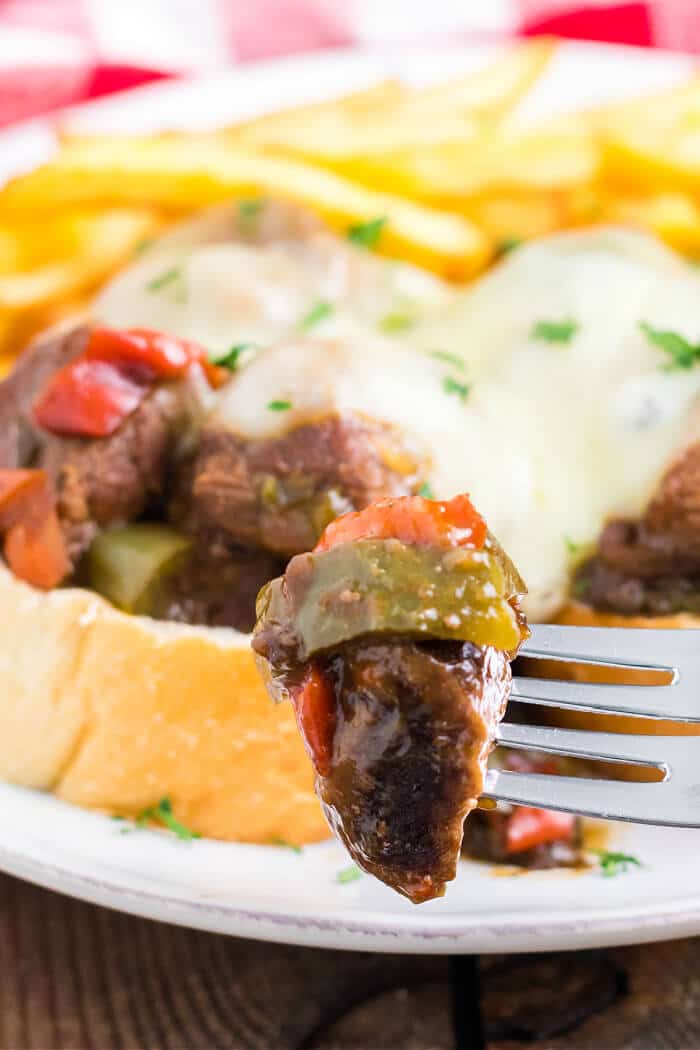 Slow cooker Philly cheesesteaks are a simple and delicious dump and go meal made with beef, peppers, onions, au jus mix, & provolone cheese. CROCK POT CHEESE STEAK