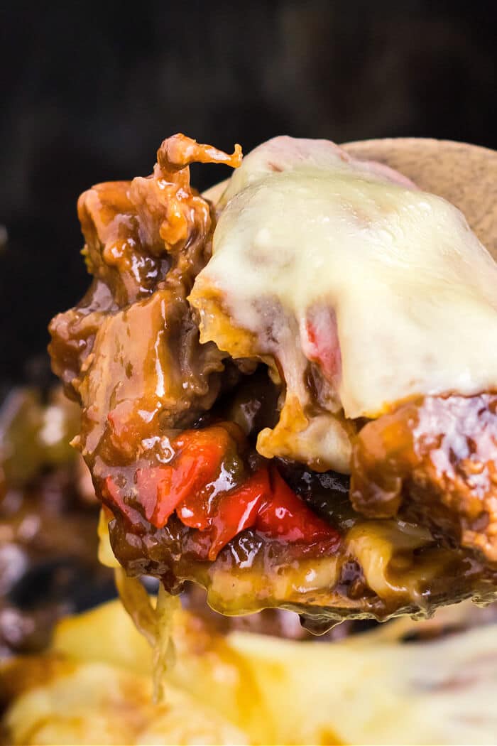 Slow cooker Philly cheesesteaks are a simple and delicious dump and go meal made with beef, peppers, onions, au jus mix, & provolone cheese. CROCK POT PHILLY CHEESE STEAK