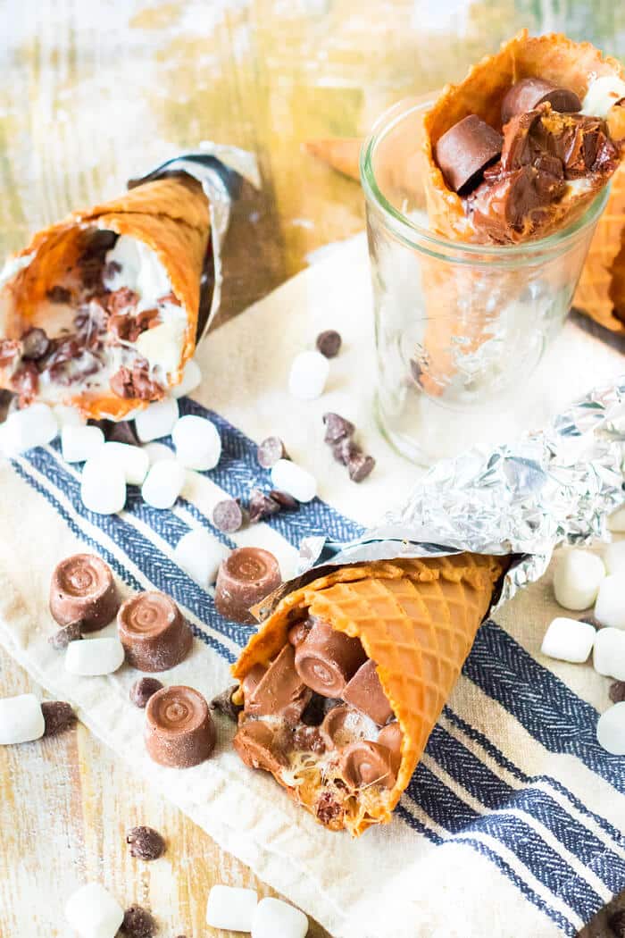 Campfire cones are a fun treat to make for your next get together made with waffle cones, mini marshmallows, and chocolate candy. CAMPFIRE CONES RECIPE