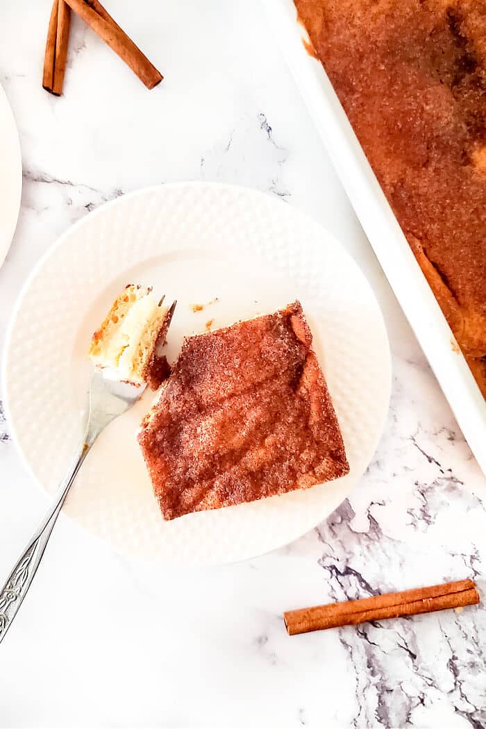 Churro cheesecake bars are a delicious homemade cheesecake layered between crescent rolls and topped with a burst of cinnamon sugar flavor! CHURROS CHEESECAKE BARS