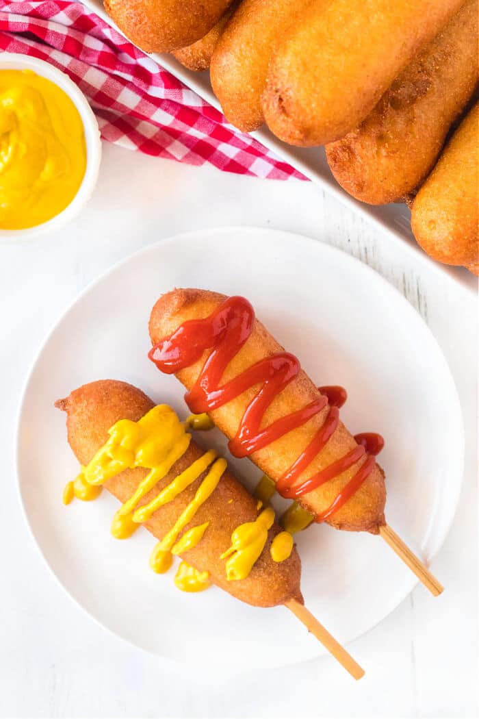 Homemade corn dogs are a delicious treat made with hot dogs, corn meal, buttermilk and honey for nostalgic perfection. CORN DOGS RECIPE