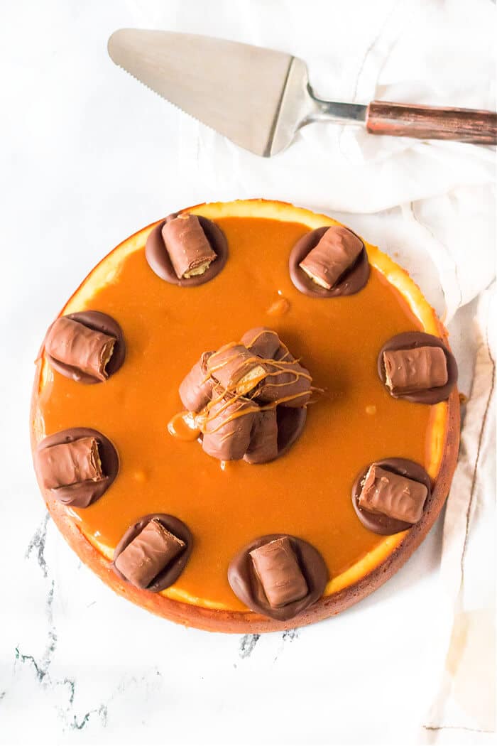 Twix cheesecake is a delightful dessert made with a cookie crust and homemade cheesecake topped with caramel, chocolate and of course, Twix! CREAMY TWIX CHEESECAKE