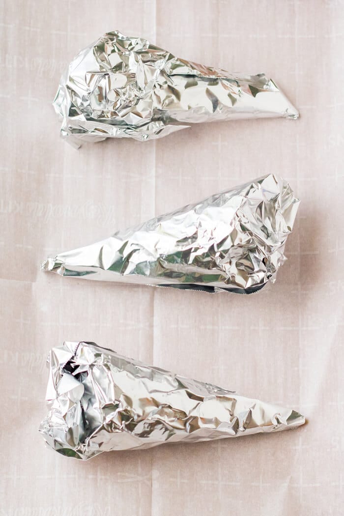 Campfire cones are a fun treat to make for your next get together made with waffle cones, mini marshmallows, and chocolate candy. HOW TO MAKE CAMPFIRE CONES