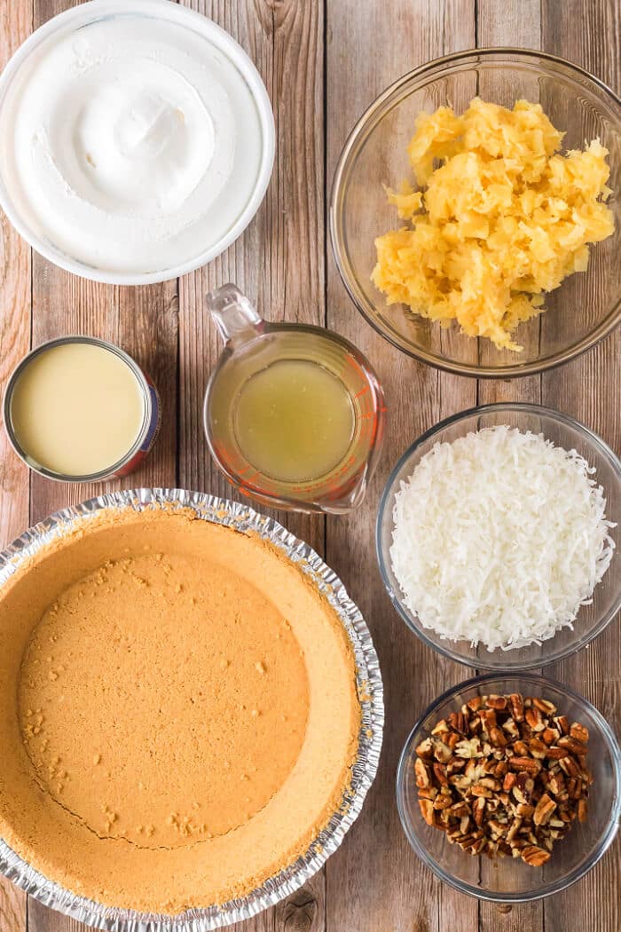 Millionaire pie is a creamy no-bake pie in a graham cracker crust with lemon juice, sweetened condensed milk, pineapple and coconut flakes! MILLIONAIRE PIE INGREDIENTS