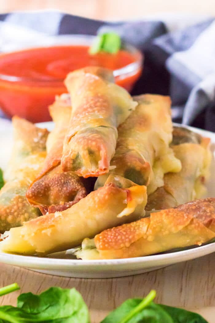 Air fryer spinach mozzarella sticks are an easy recipe made with egg roll wrappers, string cheese and baby spinach for crispy cheese sticks! MOZZARELLA STICKS IN AIR FRYER