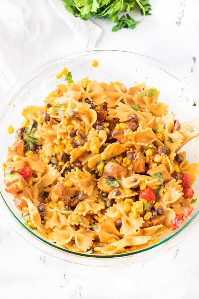 BBQ chicken pasta salad is the perfect side dish for any cookout made with BBQ chicken, ranch, tomatoes, corn, black beans & cilantro! PASTA SALAD WITH BBQ CHICKEN