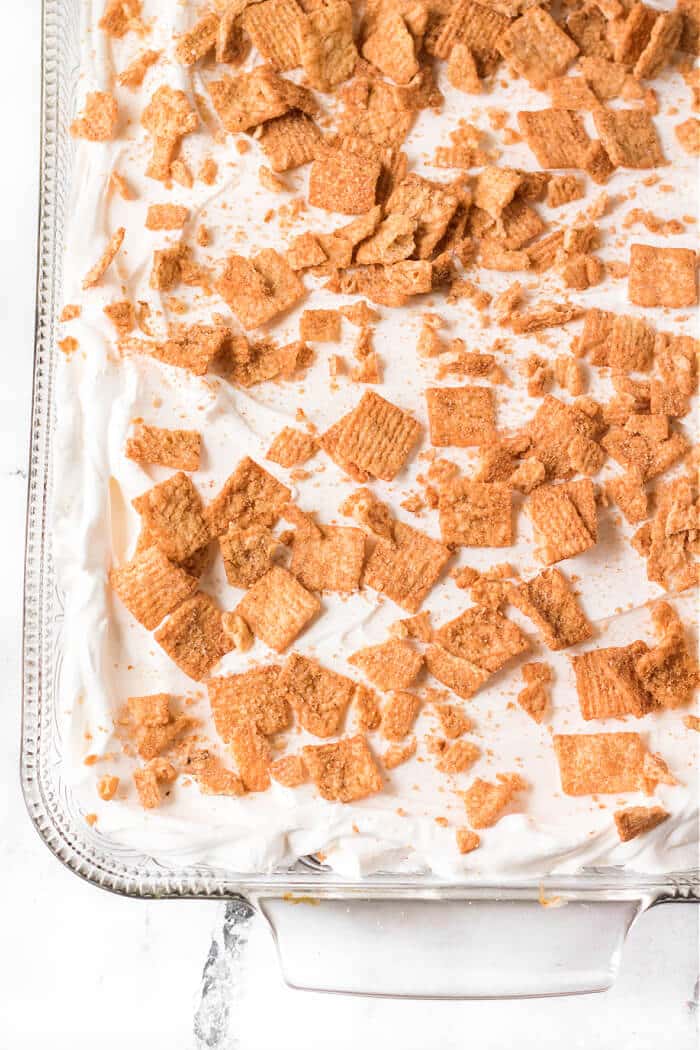 Cinnamon toast crunch poke cake combines cake mix, cinnamon, sweetened condensed milk, whipped topping & cinnamon toast crunch cereal! POKE CAKE CINNAMON TOAST CRUNCH