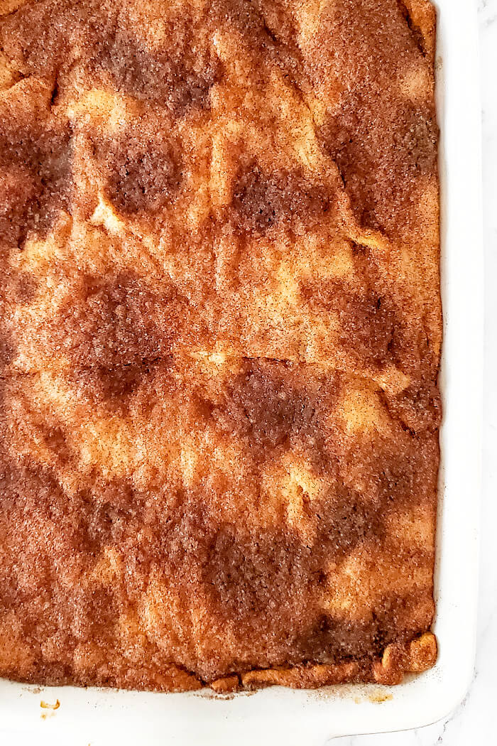 Churro cheesecake bars are a delicious homemade cheesecake layered between crescent rolls and topped with a burst of cinnamon sugar flavor! RECIPE FOR CHURRO CHEESECAKE BARS