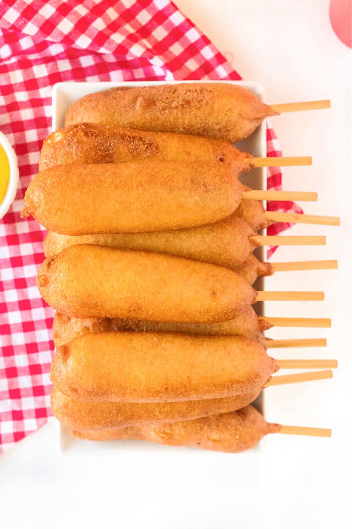 Homemade corn dogs are a delicious treat made with hot dogs, corn meal, buttermilk and honey for nostalgic perfection. RECIPE FOR CORN DOGS