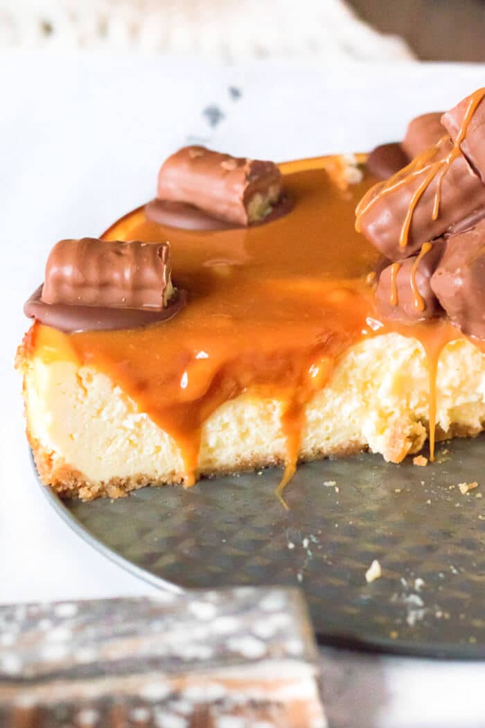 Twix cheesecake is a delightful dessert made with a cookie crust and homemade cheesecake topped with caramel, chocolate and of course, Twix! RECIPE FOR TWIX CHEESECAKE