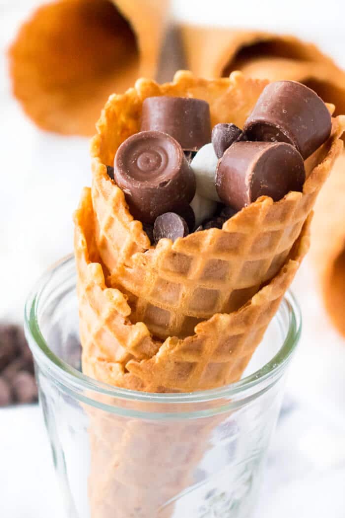 Campfire cones are a fun treat to make for your next get together made with waffle cones, mini marshmallows, and chocolate candy. STUFFED CAMPFIRE CONES