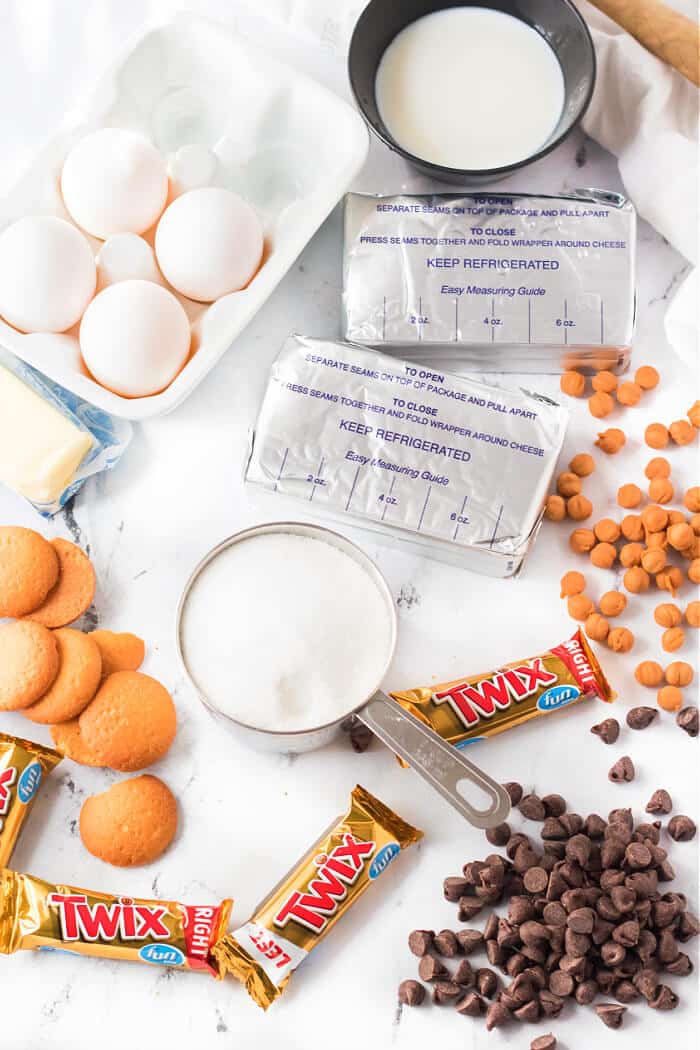 Twix cheesecake is a delightful dessert made with a cookie crust and homemade cheesecake topped with caramel, chocolate and of course, Twix! TWIX CHEESECAKE INGREDIENTS