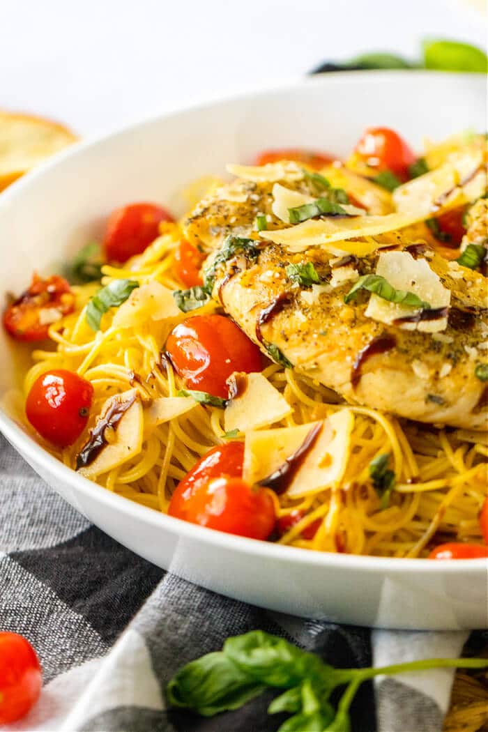 Bruschetta chicken pasta is a flavorful dish made with pasta, tomatoes, basil, garlic, balsamic glaze & chicken, topped with parmesan cheese! BRUSCHETTA CHICKEN PASTA
