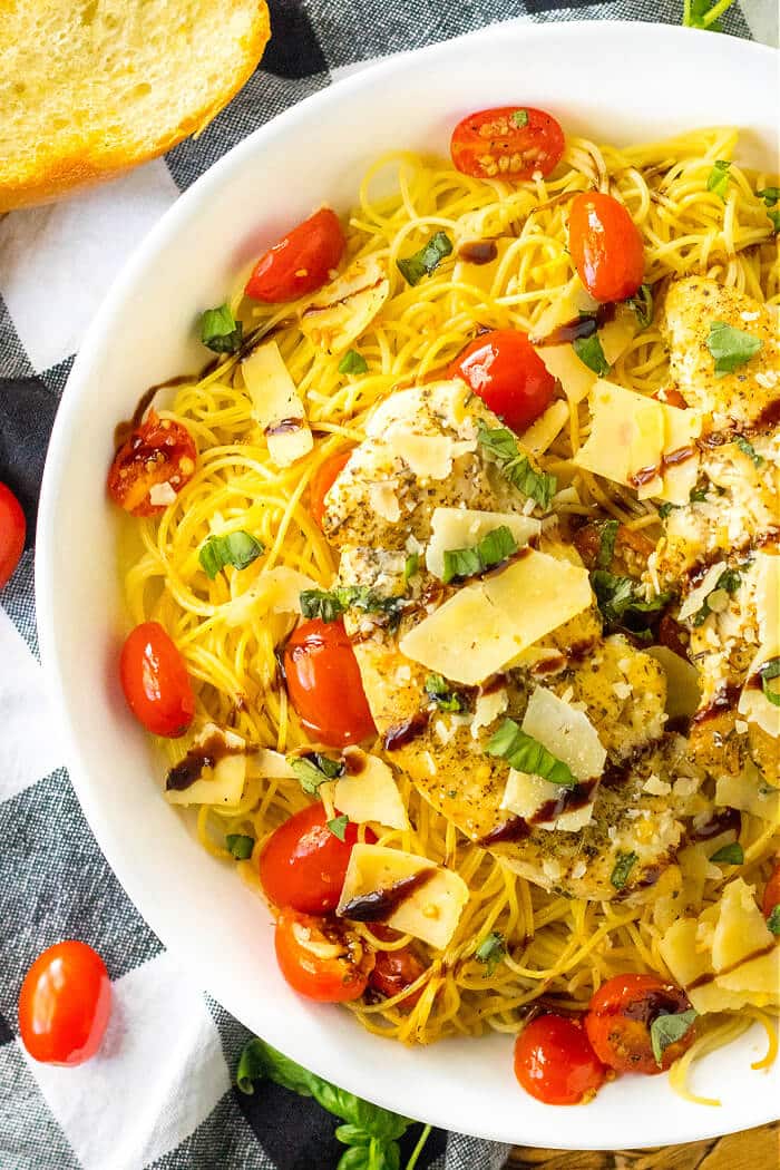 Bruschetta chicken pasta is a flavorful dish made with pasta, tomatoes, basil, garlic, balsamic glaze & chicken, topped with parmesan cheese! CHICKEN BRUSCHETTA PASTA