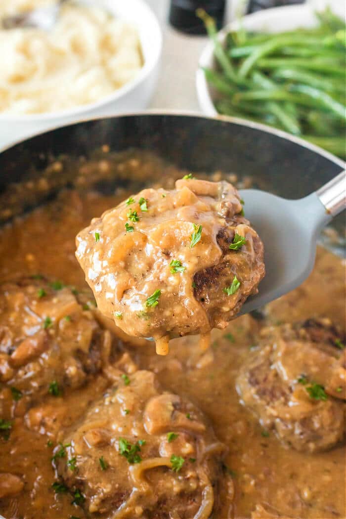 Salisbury steak is a classic dish made with seasoned ground beef cooked with sautéed mushrooms and onions in a delicious homemade gravy! HOMEMADE SALISBURY STEAK
