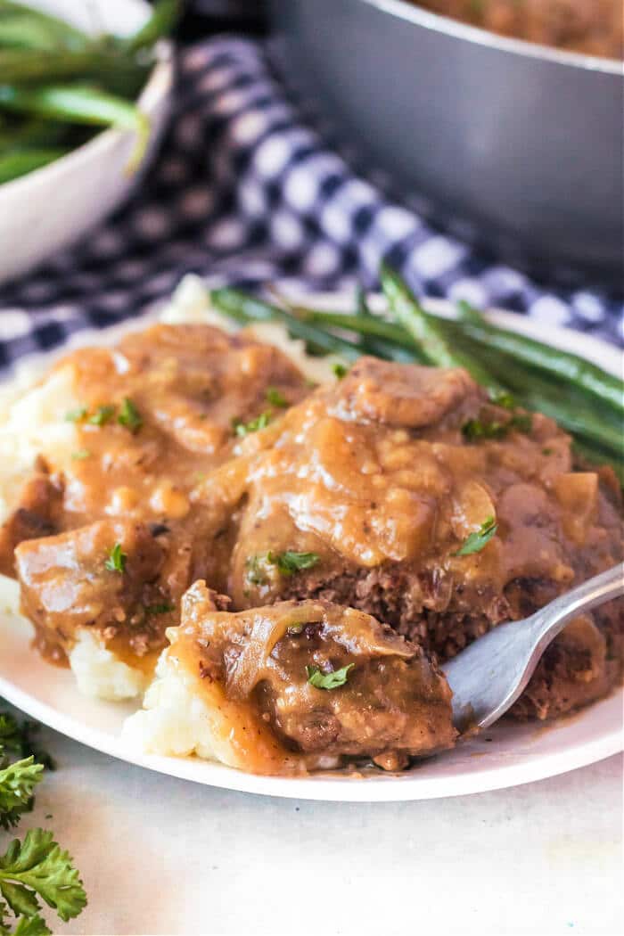 Salisbury steak is a classic dish made with seasoned ground beef cooked with sautéed mushrooms and onions in a delicious homemade gravy! RECIPE FOR SALISBURY STEAK