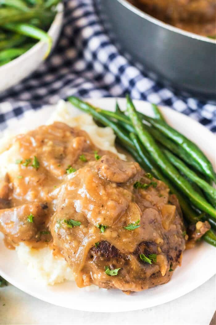 Salisbury steak is a classic dish made with seasoned ground beef cooked with sautéed mushrooms and onions in a delicious homemade gravy! SALISBURY STEAK HOMEMADE