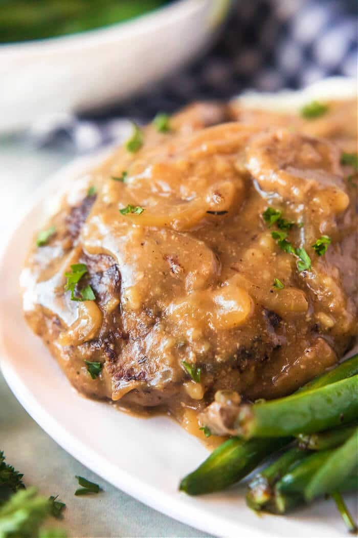 Salisbury steak is a classic dish made with seasoned ground beef cooked with sautéed mushrooms and onions in a delicious homemade gravy! SALISBURY STEAK RECIPE